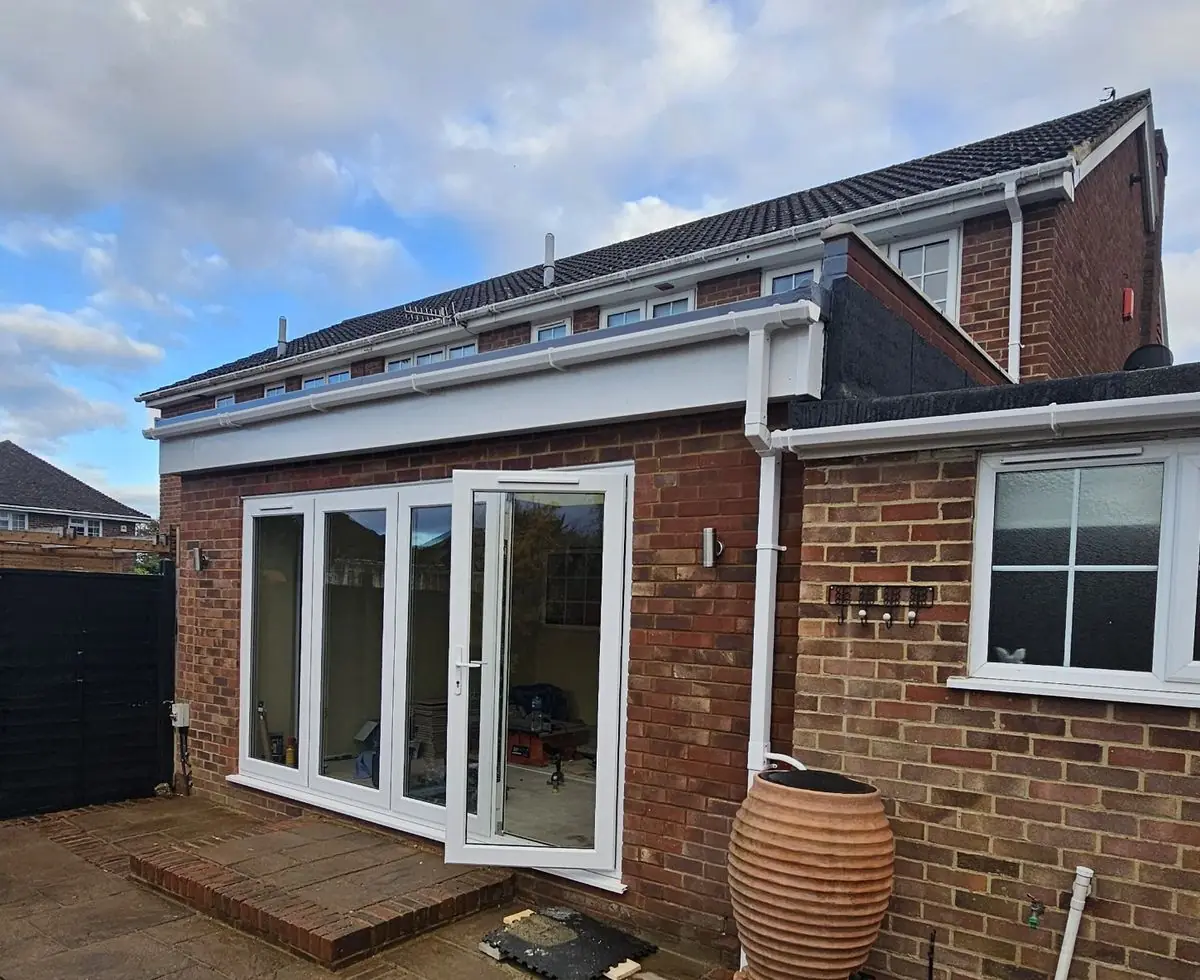 Single-storey brick rear extension with white bifold doors, built by PT Renovations