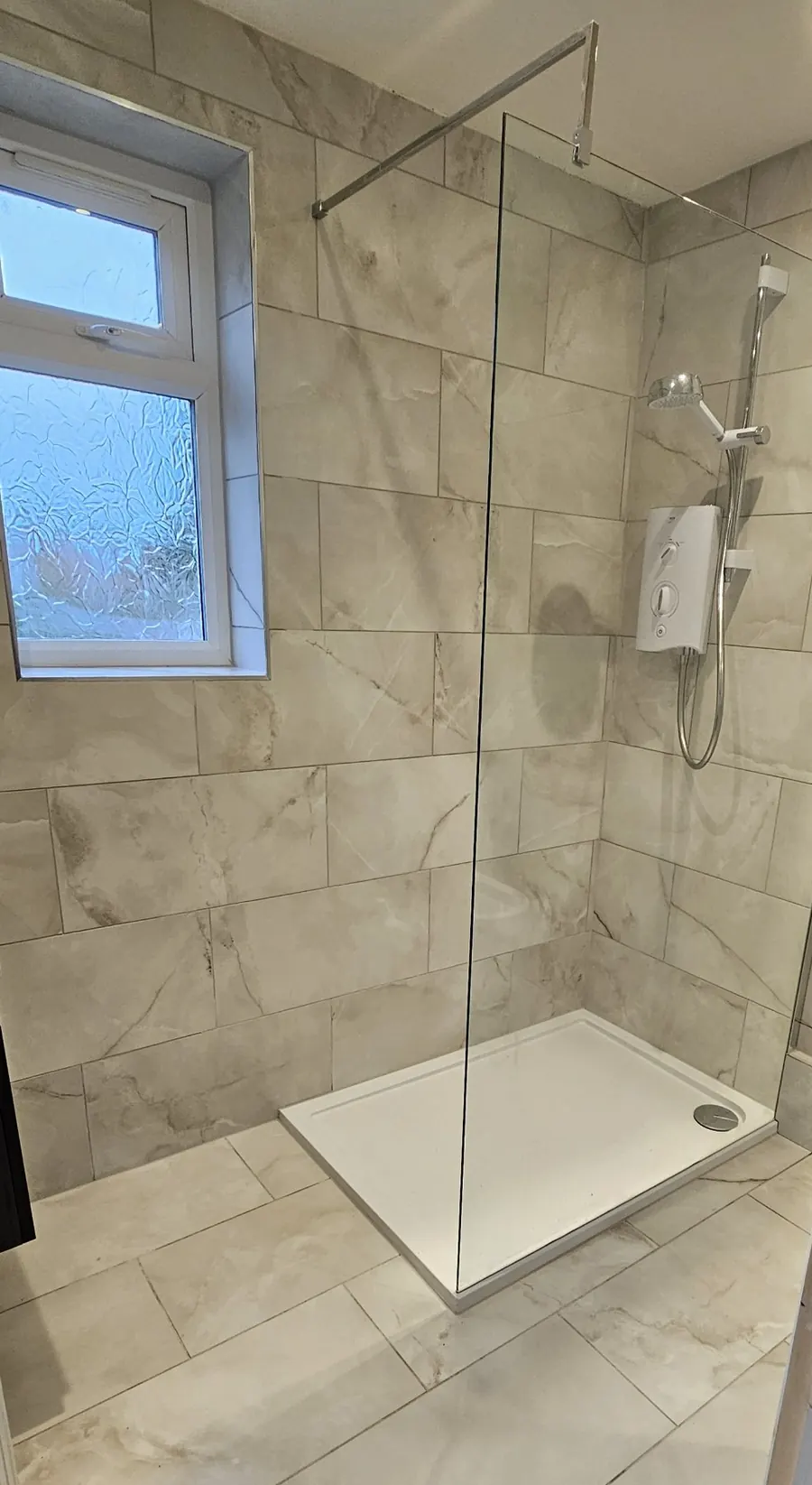 New shower room with a walk-in shower, frameless glass screen and marble-effect tiles, in Faversham